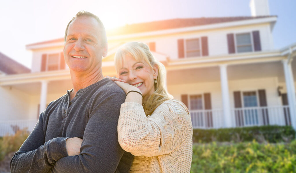 Couple in front of home